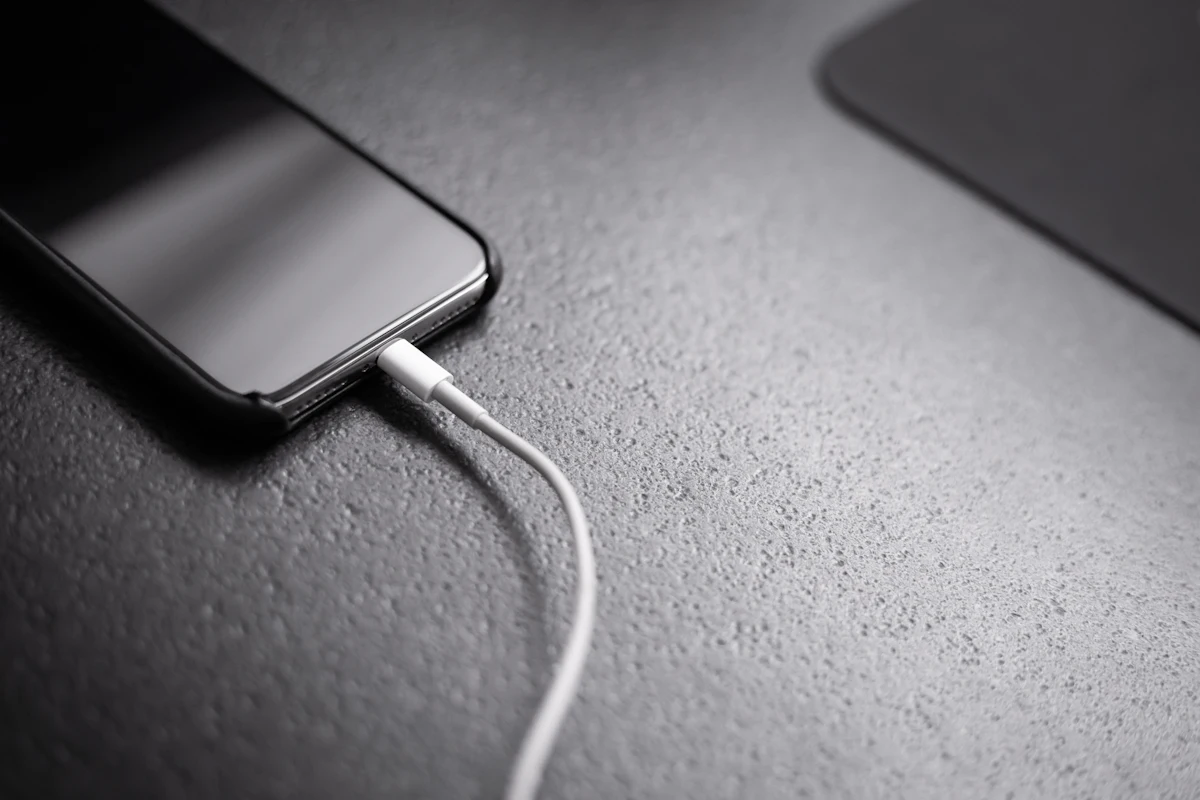 Smartphone connected to a charging cable